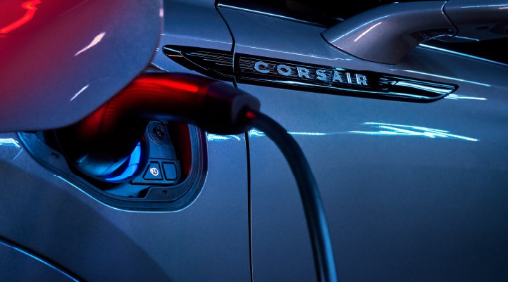 A charger plugged into the charging port of a 2024 Lincoln Corsair® Plug-in Hybrid model. | Bluebonnet Motors Lincoln in New Braunfels TX